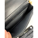 Ví cầm tay Chanel Caviar Quilted Mini Boy có dây xích màu đen